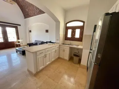 a large kitchen with white cabinets and a refrigerator at EL GOUNA Y 97-1-8 WAST GOLF in Hurghada