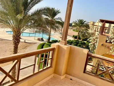 a balcony with a view of a pool and palm trees at EL GOUNA Y 97-1-8 WAST GOLF in Hurghada