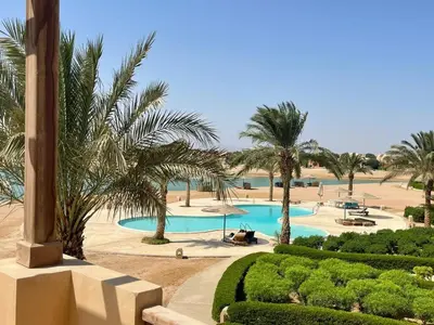 a view of a pool with palm trees and bushes at EL GOUNA Y 97-1-8 WAST GOLF in Hurghada