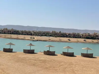 a group of chairs with umbrellas on a beach at EL GOUNA Y 97-1-8 WAST GOLF in Hurghada
