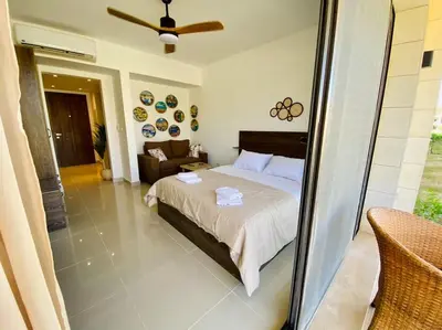 a bedroom with a bed and a couch at A Bright Studio @GCribs - El Gouna W/ Shared pool! in El Gouna
