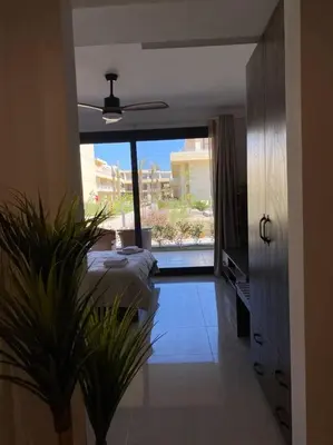 a bedroom with a bed and a large window at A Bright Studio @GCribs - El Gouna W/ Shared pool! in El Gouna