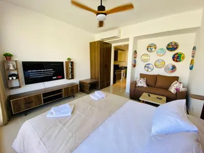 a bedroom with a large bed and a flat screen tv at A Bright Studio @GCribs - El Gouna W/ Shared pool! in El Gouna