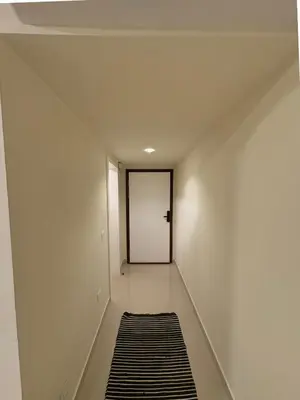 a hallway with a white wall and a door at Cozy, Calm, Studio in Veranda Sahl Hasheesh Resort in Hurghada