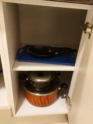 a cabinet with a pot and a pan in it at Cozy, Calm, Studio in Veranda Sahl Hasheesh Resort in Hurghada