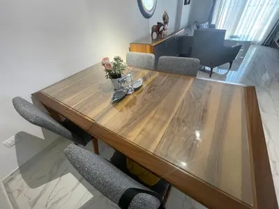 a wooden table with chairs and a vase of flowers on it at Modern HOME DownTown in Hurghada
