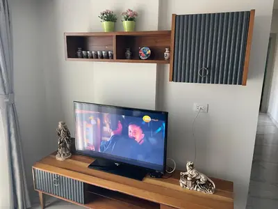 a flat screen tv sitting on top of a wooden table at Modern HOME DownTown in Hurghada