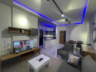 a living room with a couch and a tv in it at Modern HOME DownTown in Hurghada