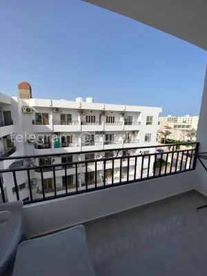 a balcony with a view of a building at Makramia New Studio near to the beach in Hurghada