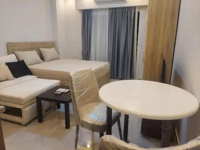 a small living room with a couch and a table at Makramia New Studio near to the beach in Hurghada