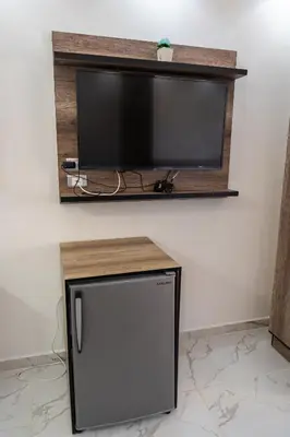a flat screen tv sitting on a wall at Juliana Beach Hurghada in Hurghada