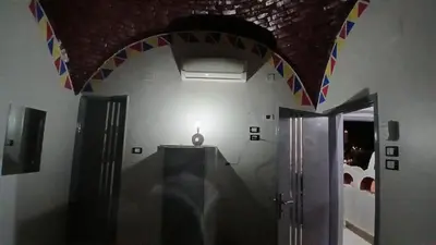 a room with a hallway with a ceiling with flags at Ezzo Nubian guest house in Aswan