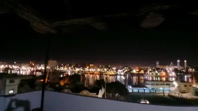 a view of a city at night with lights at Ezzo Nubian guest house in Aswan