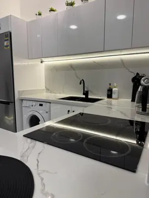 a kitchen with a sink and a washing machine at Marina View Apartment in Hurghada