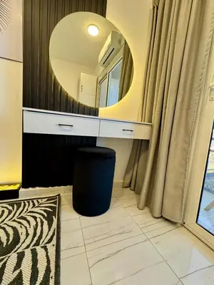 a bathroom with a vanity with a mirror at Marina View Apartment in Hurghada