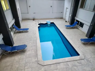 an overhead view of a swimming pool with chairs and chairs at Marina View Apartment in Hurghada