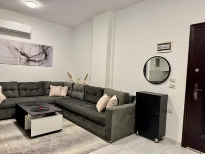 a living room with a couch and a mirror at Marina View Apartment in Hurghada