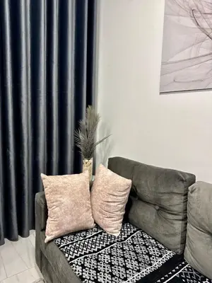 a couch in a living room with a black curtain at Marina View Apartment in Hurghada
