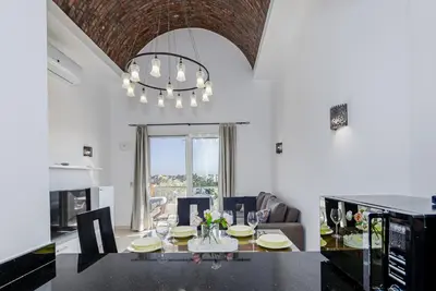 a dining room with a table and a chandelier at Wonderful apartment with prime location & pool in Hurghada