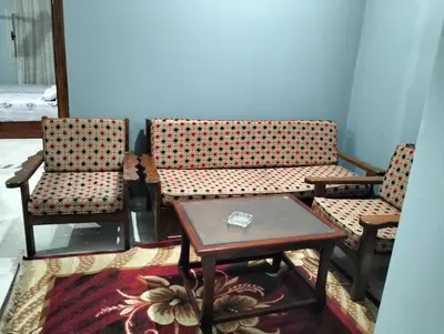 a living room with two chairs and a table at Eldon apartment in Hurghada