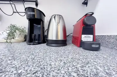 a coffeemaker and a coffee maker on a counter at Charming & Beautifully Styled 3BDR Swan Lake Gouna in Hurghada