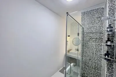 a bathroom with a shower with a glass door at Charming & Beautifully Styled 3BDR Swan Lake Gouna in Hurghada