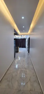 a hallway with a marble floor in a building at Elminaa Residence 6 in Luxor