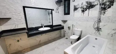 a white bathroom with a sink and a toilet at Elminaa Residence 6 in Luxor