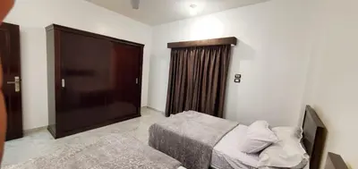 a bedroom with a bed and a large television at Elminaa Residence 6 in Luxor