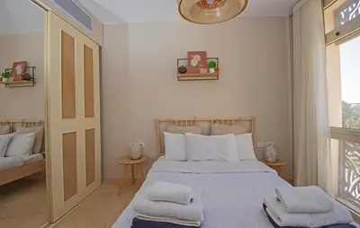 a bedroom with a bed with towels on it at Ollystays Mangroovy 1 BR Beach and Pool Free access in Hurghada