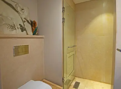 a bathroom with a shower and a toilet at Ollystays Mangroovy 1 BR Beach and Pool Free access in Hurghada