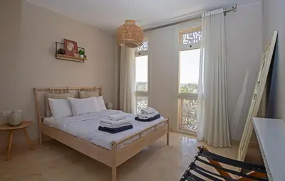 a bedroom with a bed with towels on it at Ollystays Mangroovy 1 BR Beach and Pool Free access in Hurghada
