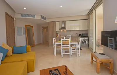 a living room with a couch and a table at Ollystays Mangroovy 1 BR Beach and Pool Free access in Hurghada