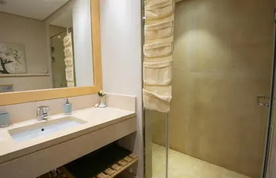 a bathroom with a sink and a shower at Ollystays Mangroovy 2 BR Beach and Pool Free access in Hurghada
