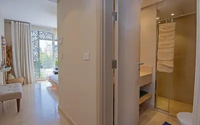 a bathroom with a walk in shower and a sink at Ollystays Mangroovy 2 BR Beach and Pool Free access in Hurghada