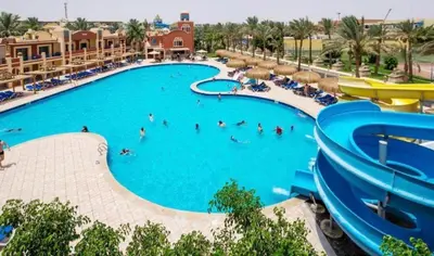 a pool at a resort with people in it at Hostgool Beach Chalets Mirage bay resort & aqua park in Hurghada