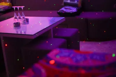 a purple room with a purple table and chairs at Hostgool Beach Chalets Mirage bay resort & aqua park in Hurghada