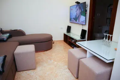 a living room with a couch and a table at Hostgool Beach Chalets Mirage bay resort & aqua park in Hurghada
