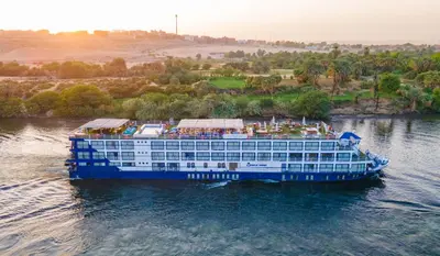 a cruise ship in the water on a river at 5 Days / 4 Nights Cruise Trip from Luxor to Aswan With all Visits Every Saturday, Monday and Thursday in Luxor