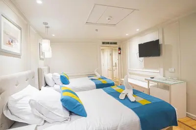 two beds in a hotel room with a tv at 5 Days / 4 Nights Cruise Trip from Luxor to Aswan With all Visits Every Saturday, Monday and Thursday in Luxor