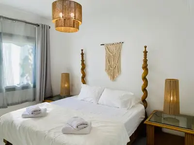 a bedroom with a bed with two towels on it at Ground Spacious 1-BR Apt @ SwanLake El Gouna ! in Hurghada