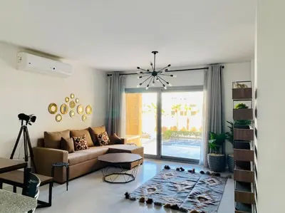a living room with a couch and a table at Ground Spacious 1-BR Apt @ SwanLake El Gouna ! in Hurghada
