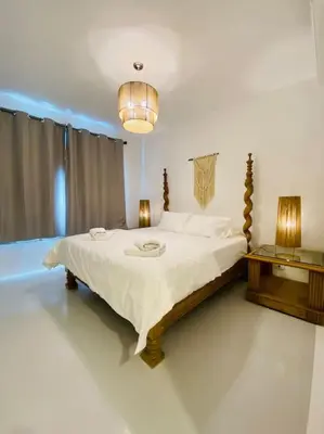 a bedroom with a large bed and two lamps at Ground Spacious 1-BR Apt @ SwanLake El Gouna ! in Hurghada