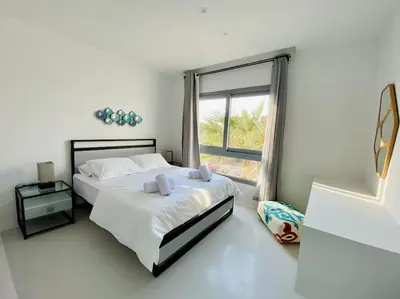 a bedroom with a bed and a large window at Rustic 1 BR-Apt@ Swanlake El Gouna ! in Hurghada