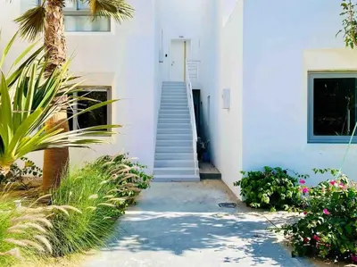 a stairway leading to a white building with a staircase at Rustic 1 BR-Apt@ Swanlake El Gouna ! in Hurghada