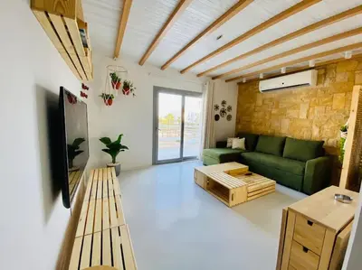 a living room with a green couch and a table at Rustic 1 BR-Apt@ Swanlake El Gouna ! in Hurghada
