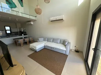 a living room with a couch and a table at Shedwan 3 bed and nanny room townhouse in Hurghada