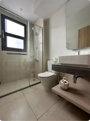 a bathroom with a shower and a toilet and a sink at Shedwan 3 bed and nanny room townhouse in Hurghada