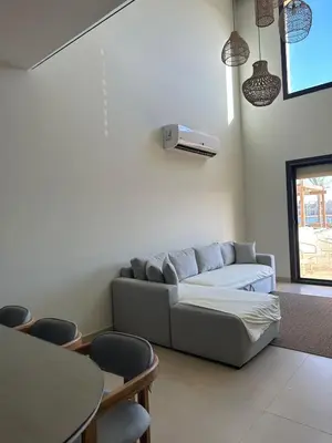 a living room with a couch and a table and chairs at Shedwan 3 bed and nanny room townhouse in Hurghada