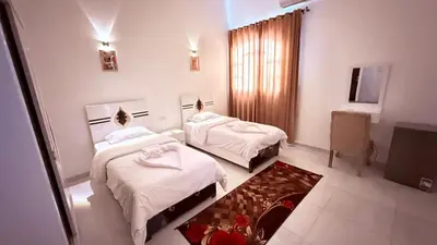 a hotel room with two beds and a television at Panorama Hotel in Luxor